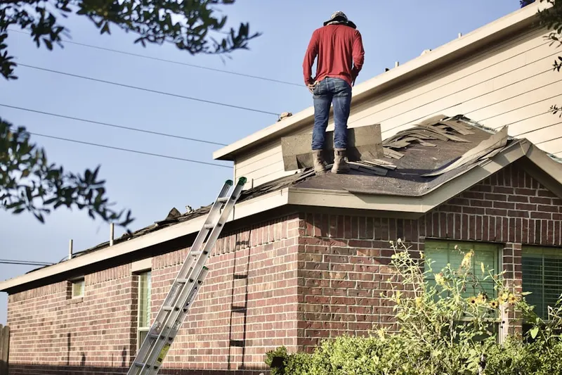 Professional roofer working on a residential roof in West Lafayette
